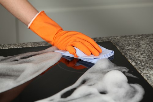 Technician cleaning a sofa upholstery in an East London property