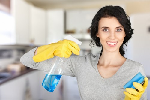 Local oven cleaner working in a modern E15 flat kitchen