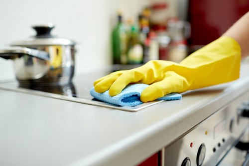 Professional cleaner working in an E15 apartment hallway