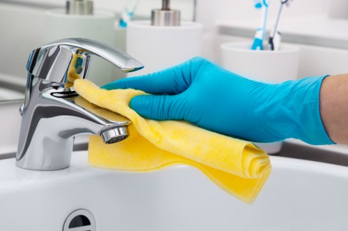 Cleaner preparing a tidy residential room in E15